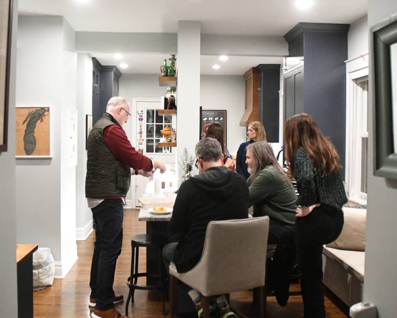 Community members gather in the kitchen area of the Augustine Home during the Holiday Sip and Sweet Tour event held in La Grange on Sunday Dec. 17, 2023.