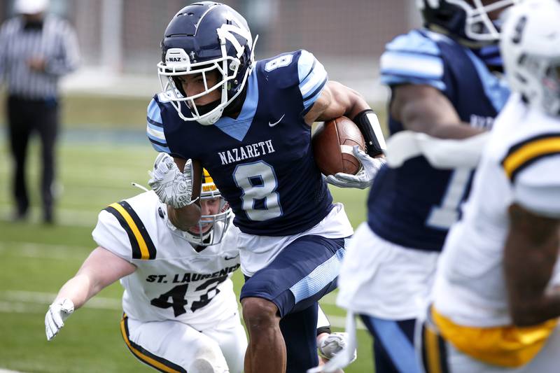 Nazareth’s Tyler Morris tries to get past St. Laurence defense during their football game at Nazareth Academy in LaGrange Park, Ill., on Saturday, March 27, 2021.