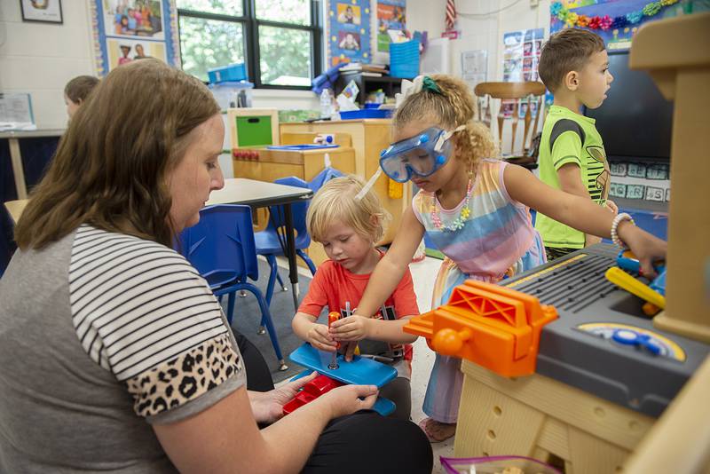 Preschoolers Ryland (left) and Westlyn help teacher Dykstra construct an airplane during play time Thursday, Sept. 15, 2022.