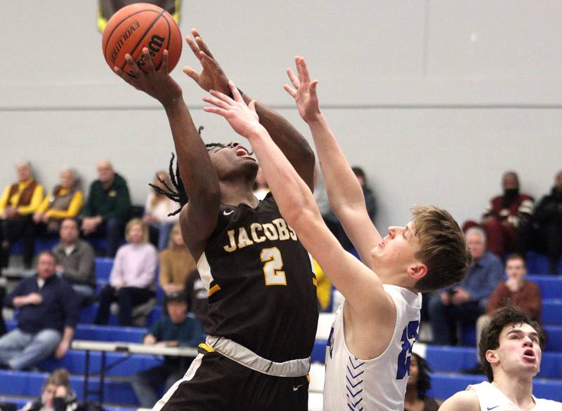 Burlington Central’s Jacob Johnson guards Jacobs’ Treval Howard in varsity boys basketball at Burlington Tuesday night.