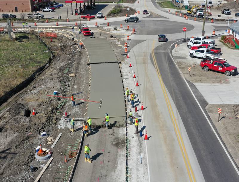 Workers pour a large section on the south side of the roundabout at the intersection of Route 71 and Illinois 178 on Tuesday, April 11, 2023 in Utica.