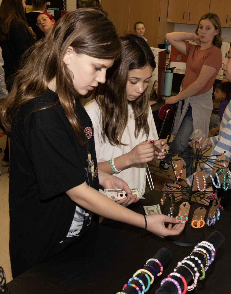 Alexis Ehret and Kailey Engel, both sixth graders at Central Intermediate School in Ottawa look at handmade jewelry for sale during the Lemonade Day Junior Market Tuesday.