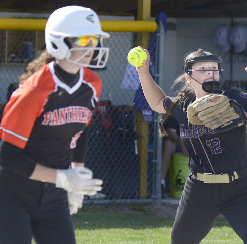 Serena’s Finley Brodbeck sets to fire to first base as Gardner-South Wilmington’s Bella Dinelli tries to beat out an infield hit Friday at Serena.