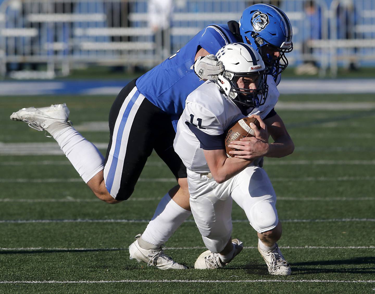 Cary-Grove's Peyton Seaburg runs for a first down on a fourth down play as Lake Zurich's George Dicanio tries to tackle him during a IHSA Class 6A semifinal playoff football game on Saturday, Nov. 18, 2023, at Lake Zurich High School.