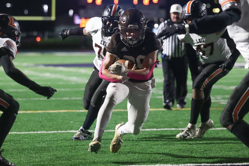 Joliet Catholic’s Keegan Farnaus secures the ball as he runs in for the touchdown against Leo on Friday, Oct. 6, 2023 in Joliet.