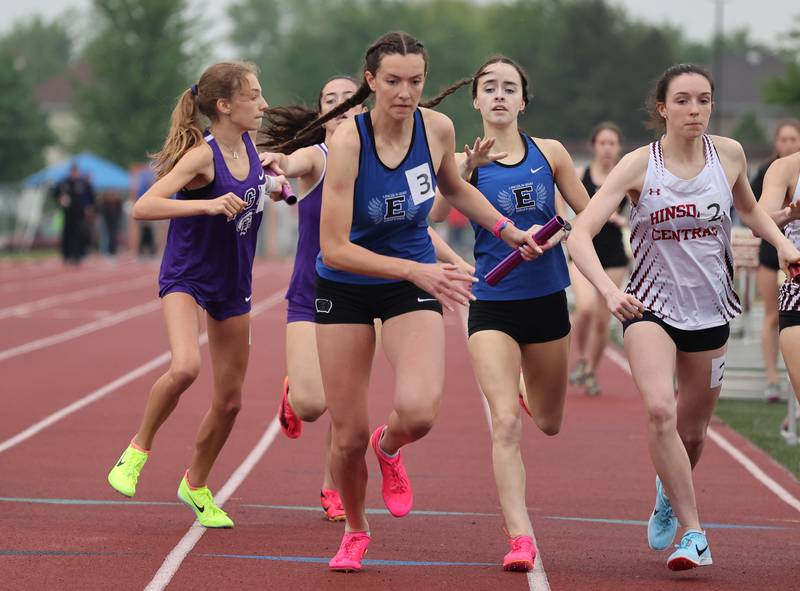 Lincoln Way East's Maddie Yacobozzi (3) gets the baton from Katie O'Brien during the 4 x 800 relay at the girls varsity track and field 3A Lockport sectional on Friday, May 12, 2023.