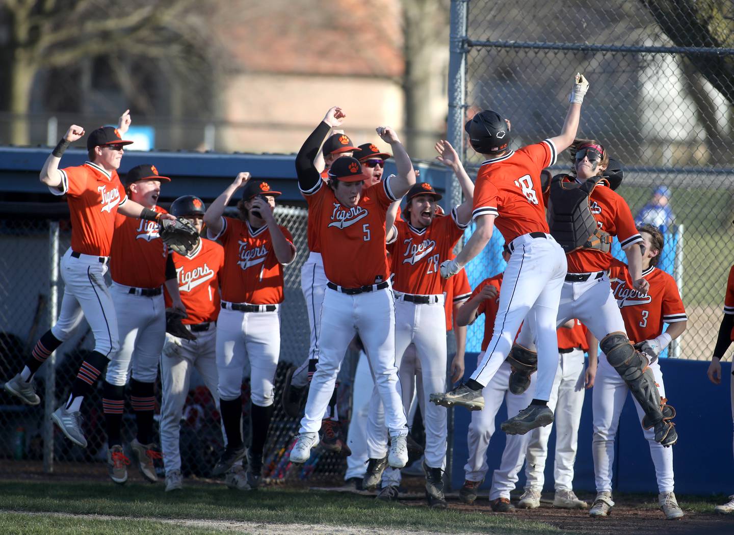 Wheaton Warrenville South players celebrate a homerun by Jacob Conover during a game at Geneva on Monday, April 8, 2024.