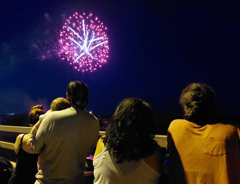 Spectators watch the Ottawa Independence Day fireworks Tuesday, July 4, 2023, from Veterans Memorial Bridge.