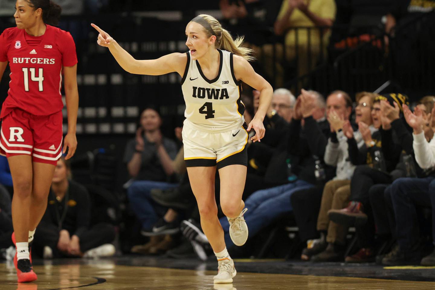 Iowa Hawkeyes guard Kylie Feuerbach (4) points out an assist after making a 3-pointer during the second half of the game against Rutgers at the Carver-Hawkeye Arena in Iowa City, Iowa on Thursday, February 13, 2025. (James Cmelo/hawkeyesports.com)