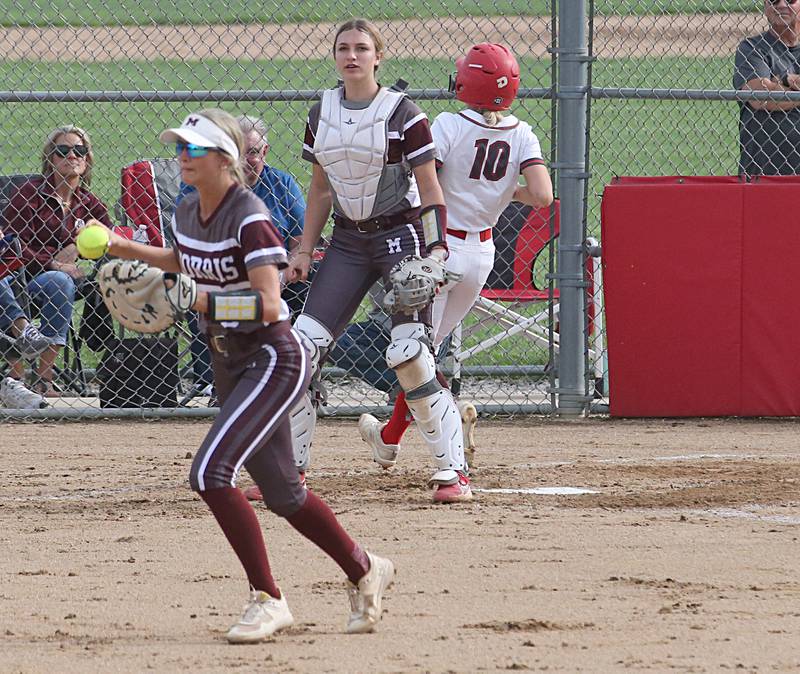 Morris pitcher Natalie Lawton holds the ball while Ottawa's Ryleigh Stehl scores a run on Monday, May 15, 2023 at Ottawa High School.