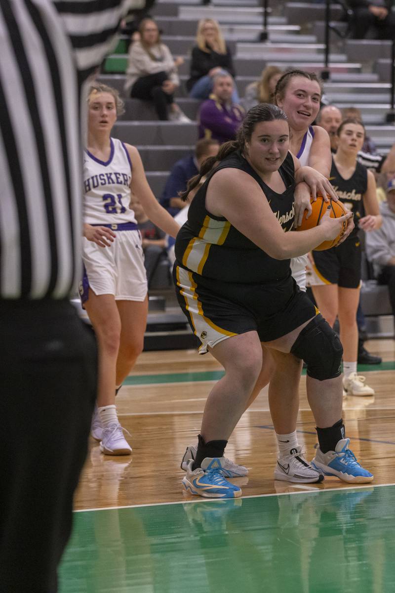 Herscher's Anistin Hackley battles a Serena athlete for possession of the ball during the Falcon-Irish Girls Basketball Tournament on November 19, 2024 at Seneca High School.