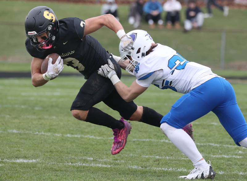 Sycamore's Carter York pulls away from St. Francis' James McGrath Saturday, Nov. 16, 2024, during their Class 5A quarterfinal game at Sycamore High School.