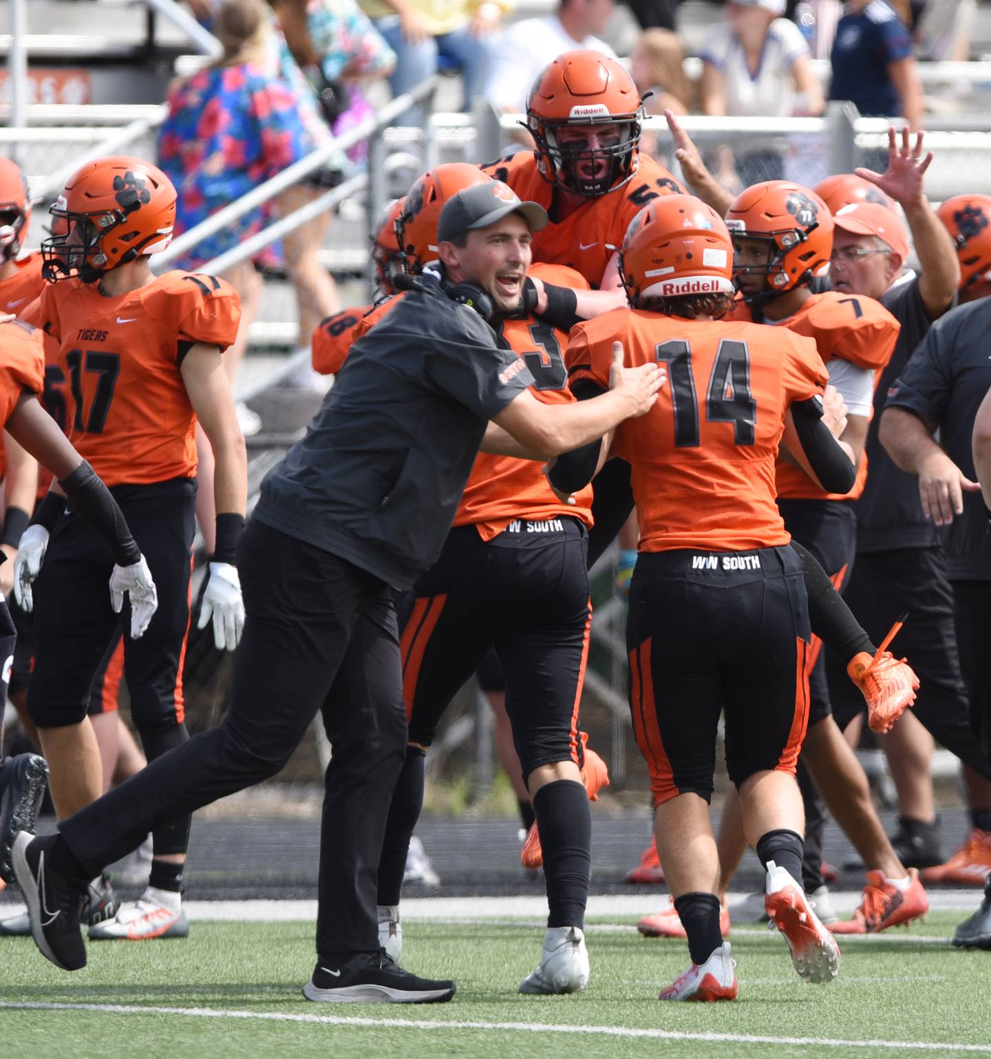 Joe Lewnard/jlewnard@dailyherald.com
Wheaton Warrenville South players and coaches celebrate after a blocked Simeon punt went for short yardage and was recovered by the Tigers during Saturday’s game in Wheaton.