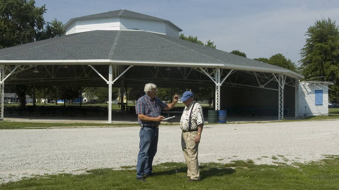 In this June 16, 2016, file photo, Ken Mueller, mayor of Pana, and Tom Phillips, publisher of the Pana News-Palladium, talk about the progress and future projects for the Chautauqua Pavilion in Pana. State money helped restore the once-rotting historic landmark in this central Illinois town that hosted traveling shows nearly a century ago featuring the likes of three-time presidential nominee William Jennings Bryan and evangelist Billy Sunday.