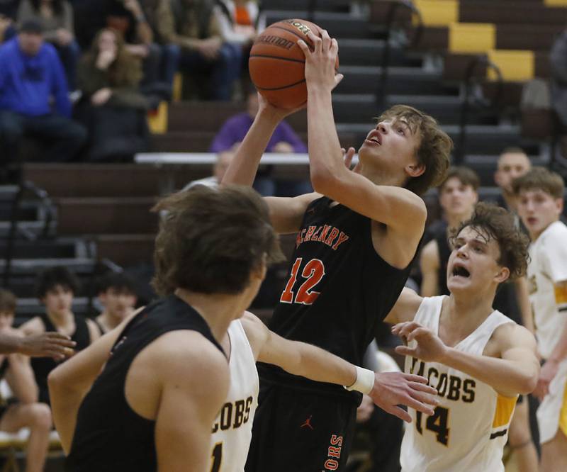 McHenry's Caleb Jett drives to the basket in front of Jacobs' Brett Schlicker during a Fox Valley Conference basketball game Wednesday, Dec. 7, 2022, between Jacobs and McHenry at Jacobs High School in Algonquin.