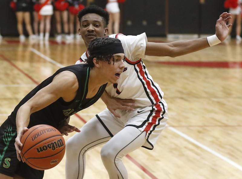 Crystal Lake South's Maddox Stroner drives to the basket against Huntley's Bryce Walker during a Fox Valley Conference boys basketball game Tuesday, Feb.6, 2024, at Huntley High School.