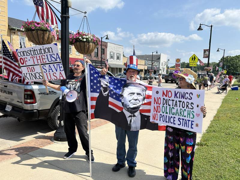 Signs critical and in support of President Donald Trump were on display during a rally in Oregon, Illinois on Saturday, June 14, 2025.
