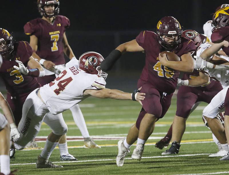 Richmond-Burton's Ethan Hile avoids the tack attempt of Morris’ Ashton Yard, left, during a Kishwaukee River Conference / Interstate 8 Conference crossover football game Friday, Sept. 30, 2022, between Richmond-Burton and Morris at Richmond-Burton Community High School in Richmond.