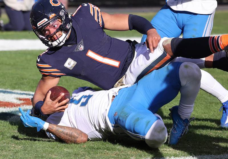 Chicago Bears quarterback Justin Fields runs over Detroit Lions safety DeShon Elliott for a touchdown during their game Sunday, Nov. 13, 2022, at Soldier Field in Chicago.
