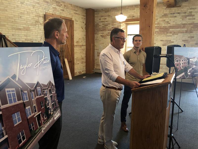 McHenry County Board Chairman Mike Buehler, center, shares remarks on Tuesday, July 30, 2024, at the second groundbreaking event for McHenry's Taylor Place apartments. According to Richard Koenig (left), of the Housing Opportunity Development Corporation and Jack Victor (right) , of Northpointe Development, construction is set to start soon for the workforce housing project.