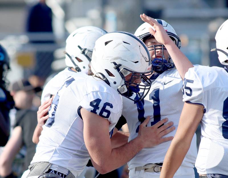 Cary-Grove’s Logan Abrams, left, and Peyton Seaburg, center, celebrate an Abrams touchdown against Highland Park in second-round IHSA Class 6A playoff action at Wolters Field in Highland Park Saturday.