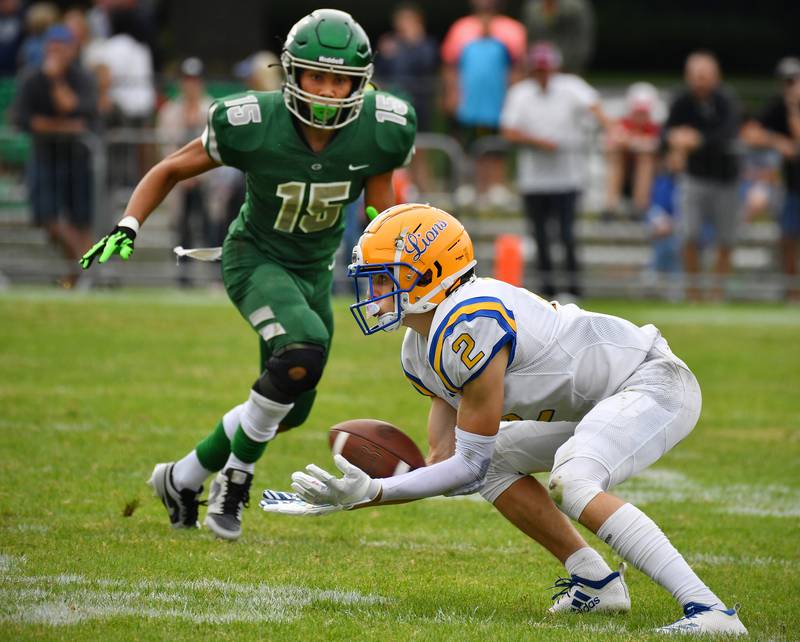 Lyons Township wide receiver Travis Stamm (2) scoops a low pass as Glenbard West's Mason Ellens (15) approaches during a game on Sep. 16, 2023 at Glenbard West High School in Glen Ellyn.