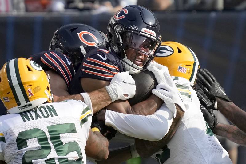Chicago Bears wide receiver DJ Moore carries the ball in traffic during the first half, Sunday, Sept. 10, 2023, against the Green Bay Packers in Chicago.