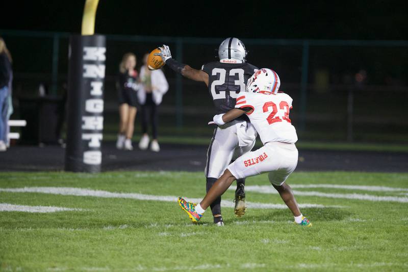 Kaneland's Aric Johnson scores a touchdown despite the efforts of Ottawa's Kevin Peterson on Friday, Sept. 22, 2023 in Maple Park.
