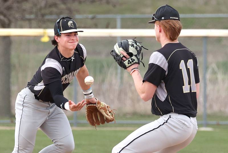 Sycamore's Nathan Lojko flips the ball to Teague Hallahan to record a force out on Rochelle's Brode Metzger during their game Wednesday, April 10, 2024, at Rochelle High School.