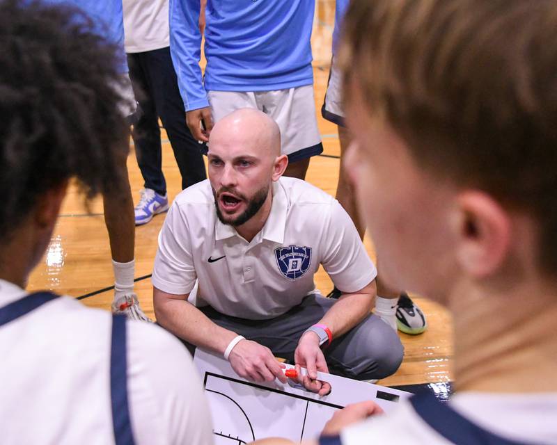 Downers Grove South's head coach Zachary Miller talks to the team between quarters on Saturday Dec. 21, 2024, while taking on crosstown rival Downers Grove North held at Downers Gove South High School.