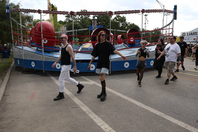 Festival goers walk past a carnival ride as the to the main stages on day two of Riot Fest. Saturday, Sept. 18, 2022, in Chicago.