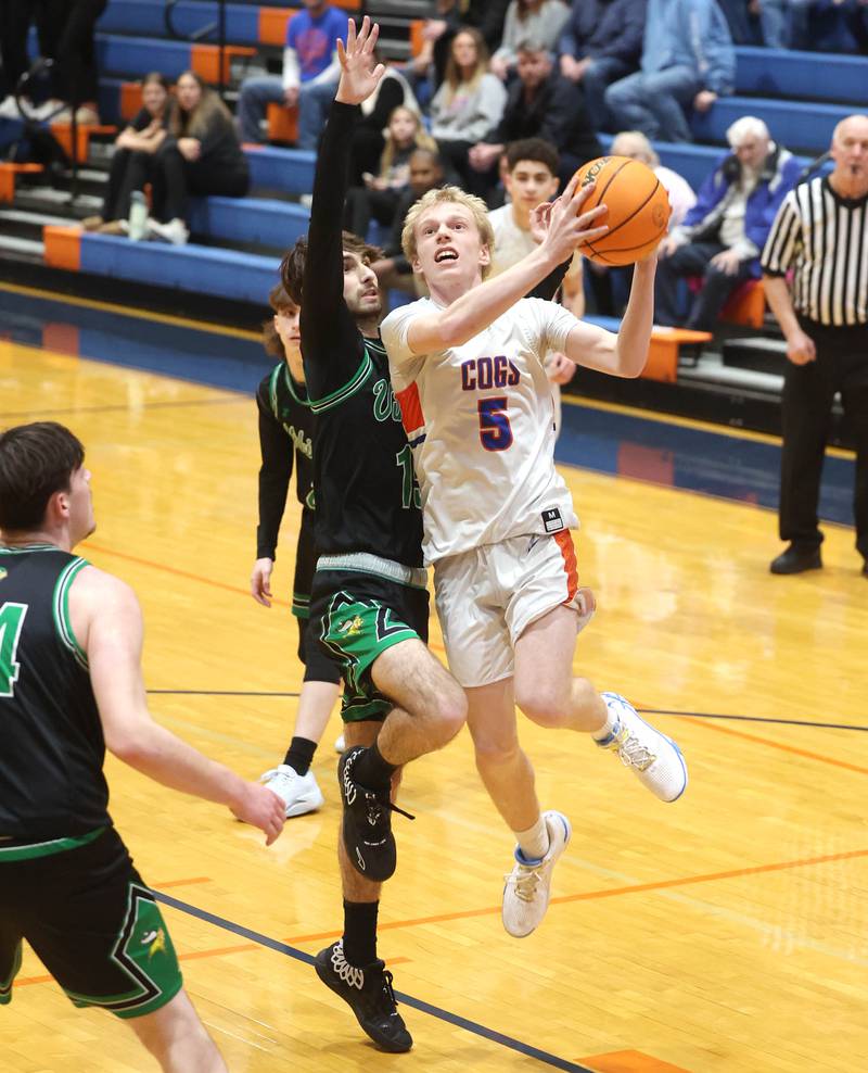 Genoa-Kingston's Blake Ides goes to the basket against North Boone's JJ Ford during their Class 2A regional game Monday, Feb. 24, 2025, at Genoa-Kingston High School.