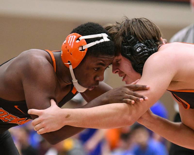 DeKalb’s Hussul Greer, left, wrestles against St. Charles East’s Ben Guskiewicz in the 175-weight class on Monday, Dec. 29, 2025, during the Flavin Invitational held at DeKalb High School.