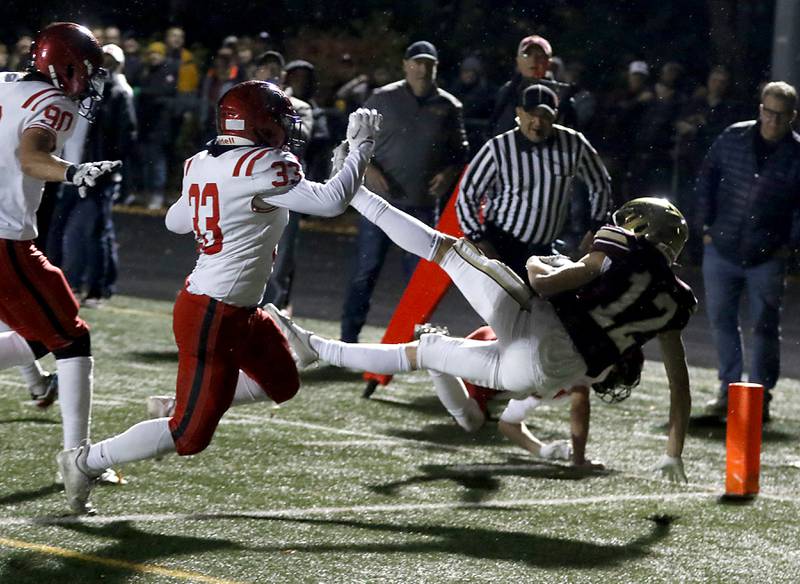 St. Ignatius' Liam Hynes scores a touchdown in front of Huntley's Charlie Condon during a IHSA Class 8A second round playoff football game on Friday, Nov. 3, 2023, at St. Ignatius College Prep in Chicago.