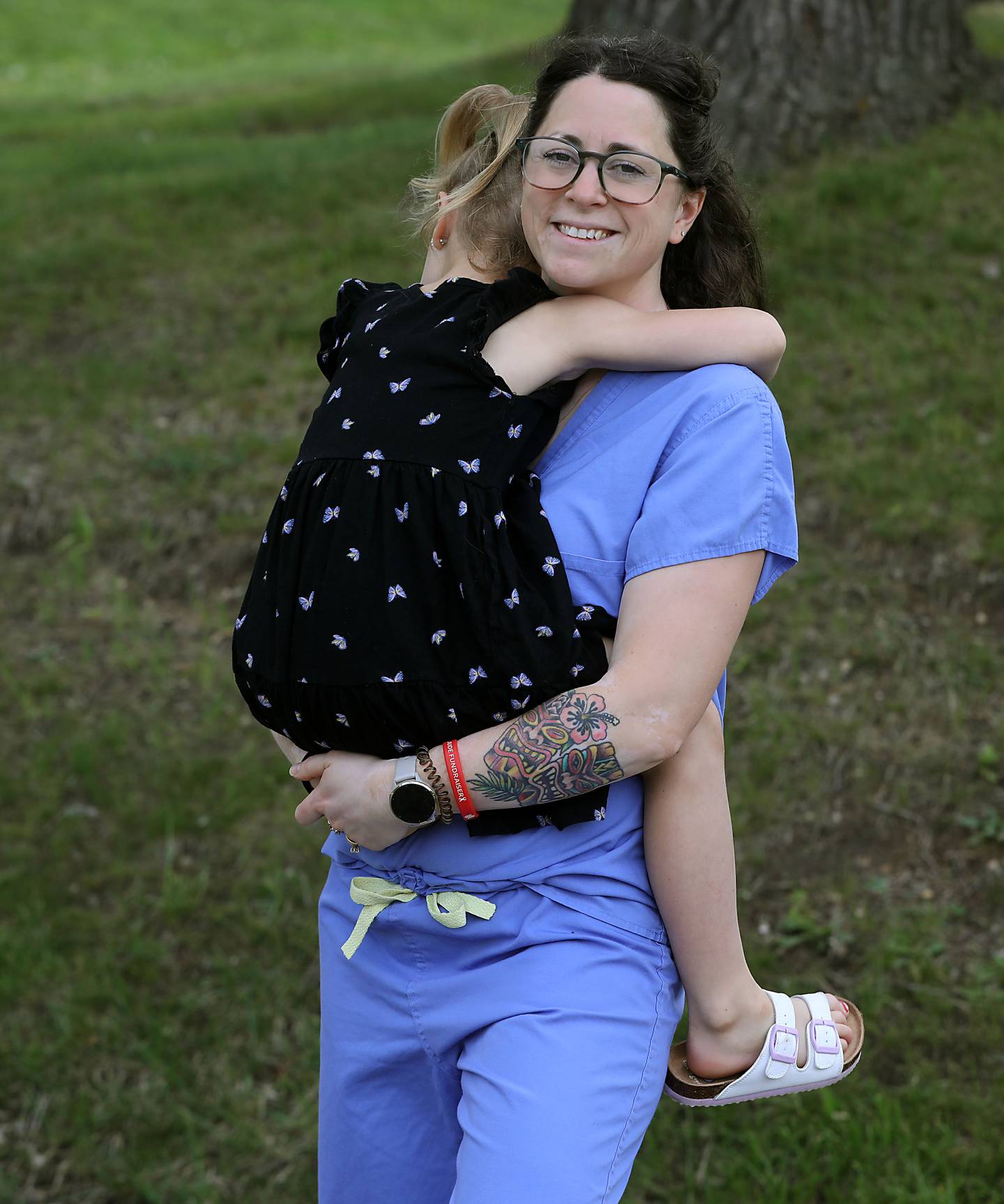 Kailee Schultz hugs her daughter on Tuesday, May 19, 2026, at their home in Johnsburg. Schultz was seven months pregnant with her daughter when a patient kicked her in the abdomen while working in the emergency room at Northwestern Medicine in McHenry.
