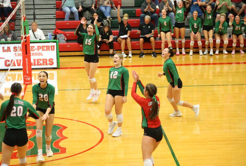 Members of the L-P volleyball team celebrate after defeating Morris on Thursday, Oct. 10, 2024 in A.J. Sellett Gymnasium at L-P High School.