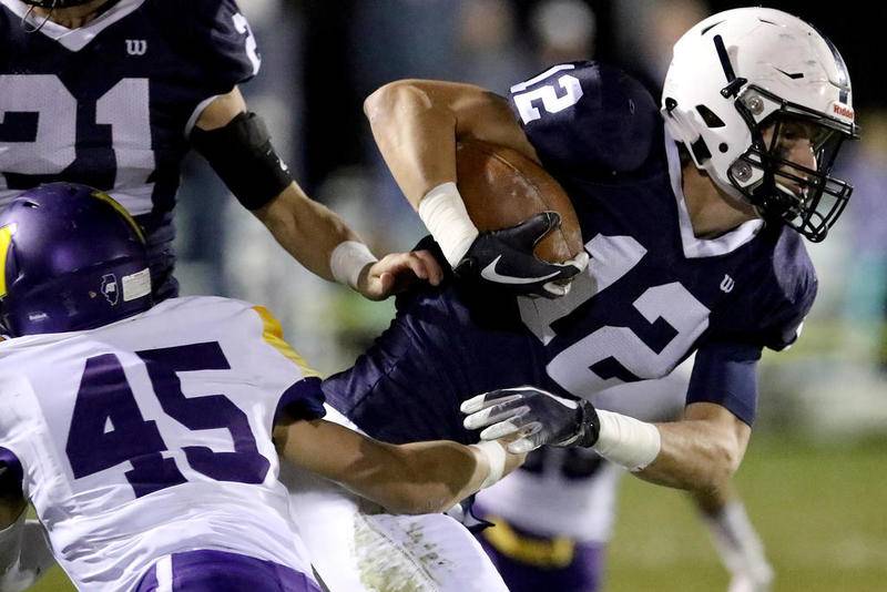 Cary-Grove's Quinn Priester breaks a tackle against Wauconda during a first-round playoff game Oct. 26 in Cary.