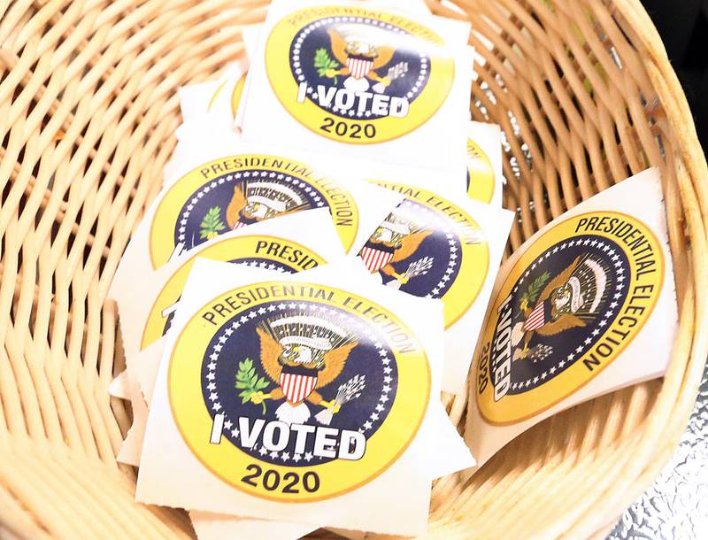 Voting stickers are placed in a basket on top of a voting machine on Election Day in La Salle County.