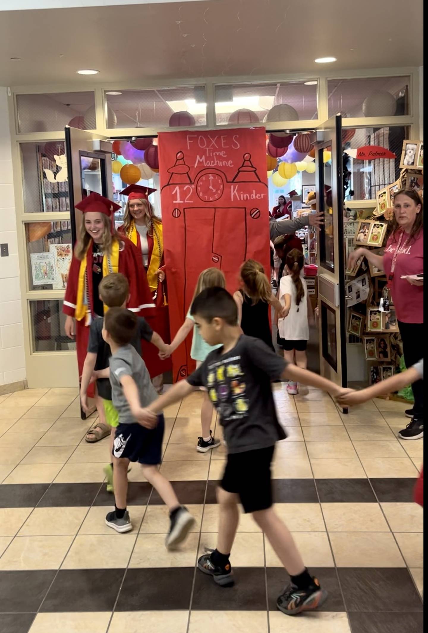 Stepping through a 'time machine,' graduating Yorkville High School seniors marched past kindergarten students at Grande Reserve Elementary School.