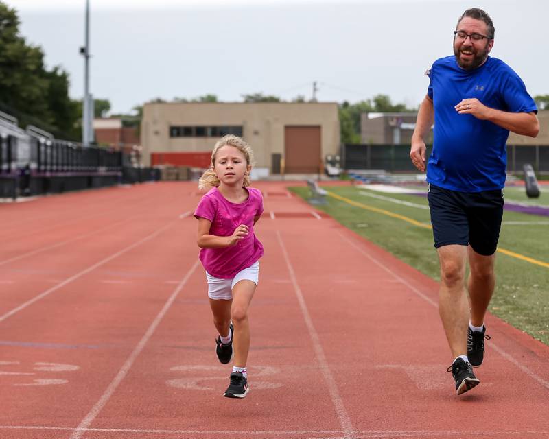 Jason Vroustouris and his daughter Emilia finish their mile heat at the community festival and running fundraiser for mental health awareness and suicide prevention in honor of Ben Silver.  July 23, 2022.