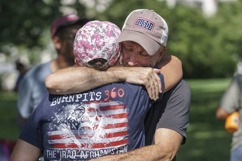 Activist and entertainer Jon Stewart hugs fellow advocate Susan Zeier of Sandusky, Ohio, just after Senate Majority Leader Chuck Schumer, D-N.Y., assured veterans and military family members that the Senate will vote on a bill designed to help millions of veterans exposed to toxic substances during their military service, at the Capitol in Washington, Tuesday, Aug. 2, 2022. (AP Photo/J. Scott Applewhite)