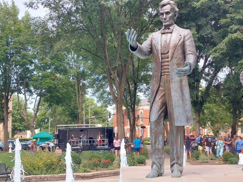 Abraham Lincoln's statue stands tall in the Washington Square fountain Saturday, July 27, 2024, as the inaugural Drinkin' with Lincoln festival attracts visitors to the site of the first Lincoln-Douglas debate.