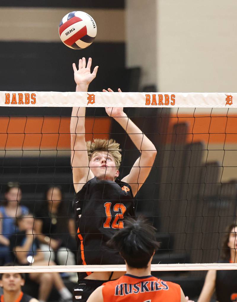 DeKalb’s Gregory Kubitz tips the ball Tuesday, April 21, 2026 during their match against Naperville North JV at DeKalb High School.