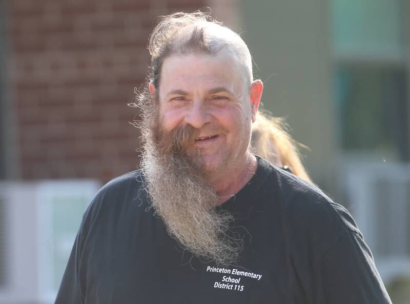 Custodian Bob Espel shows off his new look on Wednesday, May 22, 2024 at Douglas Elementary School in Princeton. Epsel shaved half of his face in the morning and half in the afternoon to accomdate preschool classes. Students raised more than $3.332 in the past few weeks. All proceeds will go to the new landscaping around the Douglas building, with the first round of plantings to take place with students present this Thursday, May 23. Using funds from the Preschool for All grant, the school has purchased new age-appropriate playground equipment to promote physical activity, creativity and social interaction.