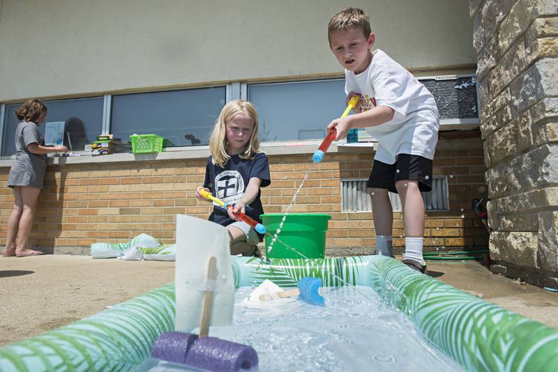 St. Anne’s School first graders Jocelyn Elliegsen and Lucas Carlson race their boats Friday during a STREAM activity in Dixon.