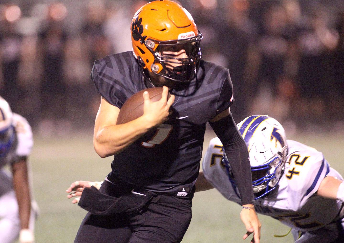 Wheaton Warrenville South quarterback Matt Sommerdyke keeps the ball during a home game against Wheaton North on Friday, Oct. 8, 2021.
