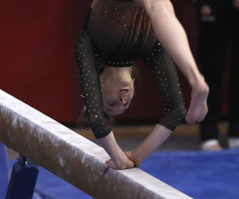 Libertyville’s Anna Baker competes in the preliminary round of the balance beam Friday, Feb. 17, 2023, during the IHSA Girls State Final Gymnastics Meet at Palatine High School.