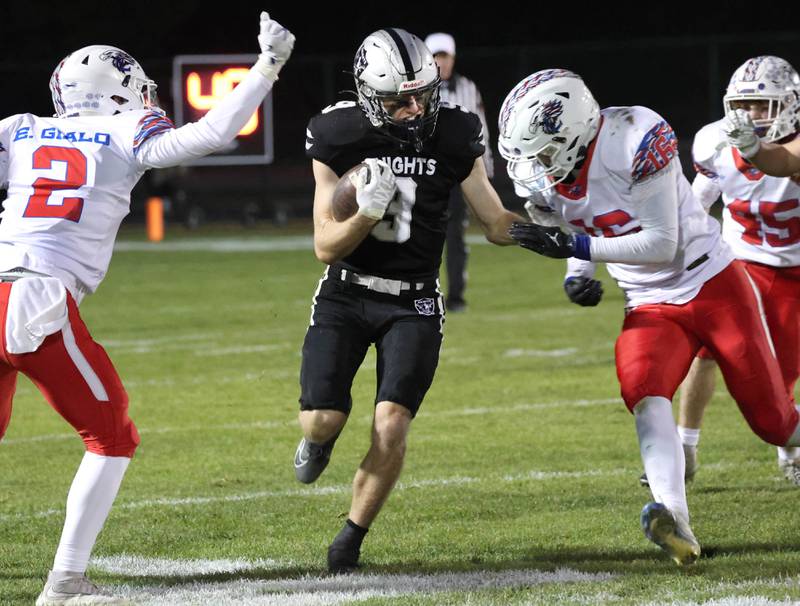 Kaneland's Carter Grabowski tries to get between Lakes' Ethan Gialo (left) and Mason Gialo Saturday, Nov. 1, 2025, during their first round playoff game at Kaneland High School in Maple Park.