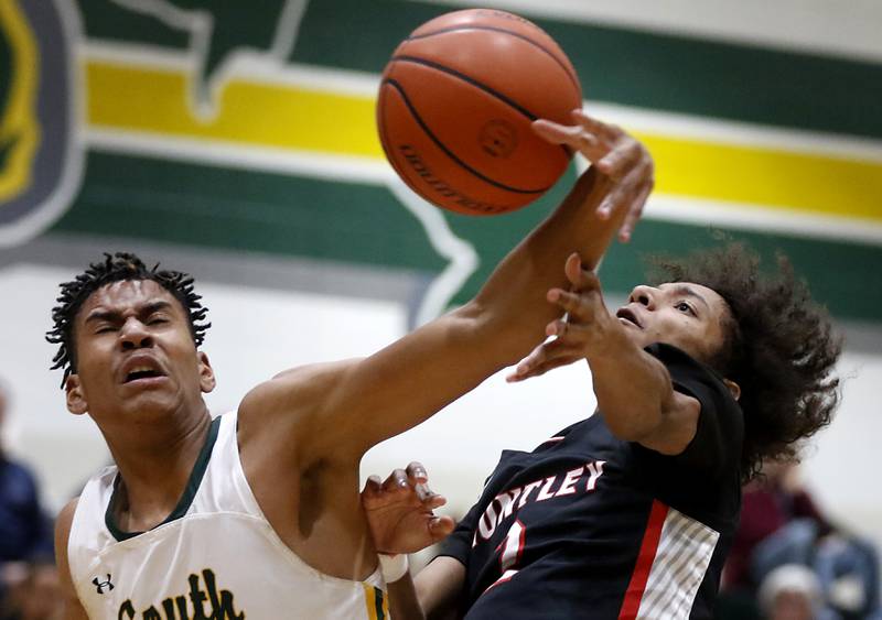 Crystal Lake South's Christian Rohde fouls Huntley's Omare Segarra as Segarra drives to to the basket during a Fox Valley Conference boys basketball game on Wednesday, Dec. 13, 2023, at Crystal Lake South High School.