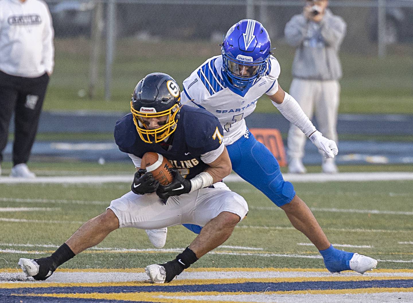 Sterling’s Andre Klaver hauls in a catch in front of St. Francis’ Corin Greenwell Saturday, Nov. 4, 2023 in a class 5A playoff game in Sterling.